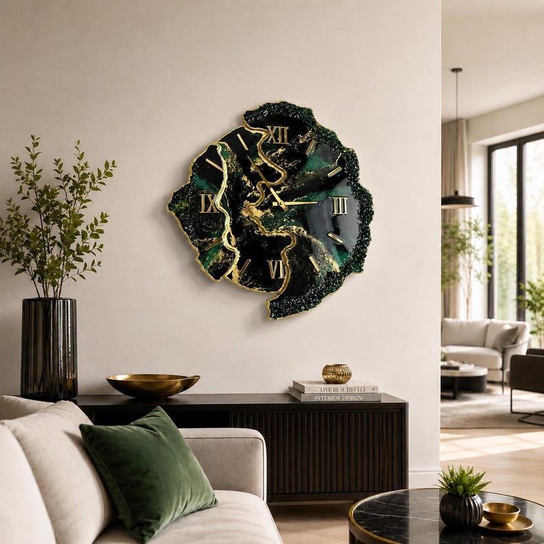 May include: A wall clock with an irregular, organic shape featuring a deep emerald green and black marbled surface with gold-colored accents. The clock face displays gold Roman numerals and thin gold hands, creating a striking contrast.