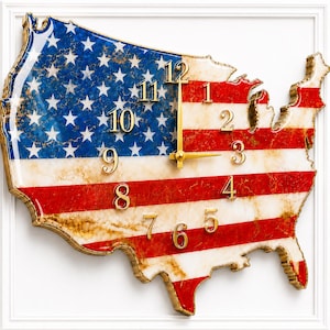 May include: A wall clock shaped like the map of the United States, featuring a glossy finish with the American flag design. The clock face displays gold-colored numerals from 1 to 12 and gold hands, set against a blue, white, and red marble-like pattern.