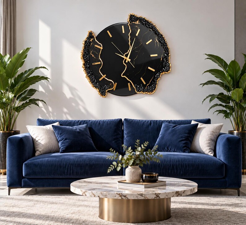 Pu&ograve; includere: Un orologio da parete circolare con quadrante nero, indici e lancette color oro. L'orologio presenta un bordo irregolare ispirato alle geodi, con texture nere e dorate che incorniciano la superficie centrale nera con venature sottili.