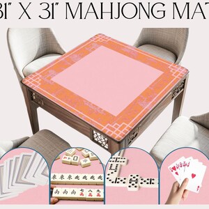 May include: A square mahjong mat, 31 x 31 inches, with a pink center and orange patterned border. The wooden table is surrounded by chairs. The image includes mahjong tiles, dominoes, and playing cards.