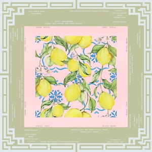 May include: A square, decorative fabric with a lemon and floral pattern on a pink background. The lemons are yellow with green leaves and blue accents. The fabric is framed by a light green border with text.