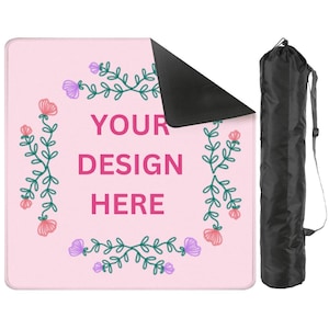 May include: A pink yoga mat with a floral design and the text "YOUR DESIGN HERE." The mat has a black underside and comes with a black carrying bag with a shoulder strap. The floral design includes pink and purple flowers.