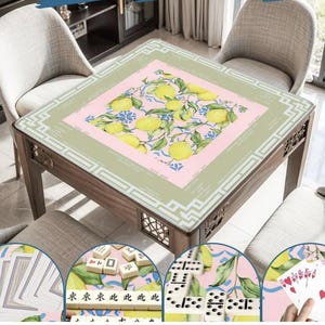 May include: A wooden game table with a decorative top featuring a lemon and floral design. The table is surrounded by four chairs. The table is designed for playing games like Mahjong, dominoes, and cards.