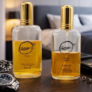 May include: Two glass cologne bottles with gold caps and amber liquid. The bottles are labeled "Stetson" and "Cologne." One bottle is 3.0 fl oz, the other is 2.25 fl oz. Accessories like a watch and cufflinks are nearby.