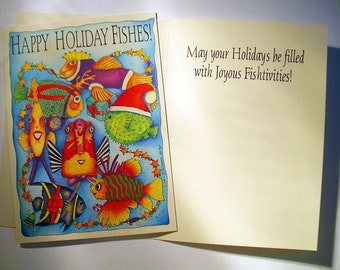 May include: A greeting card with a colorful illustration of cartoon fish in a holiday theme. The front of the card reads "HAPPY HOLIDAY FISHES!" and the inside says "May your Holidays be filled with Joyous Fishtivities!"