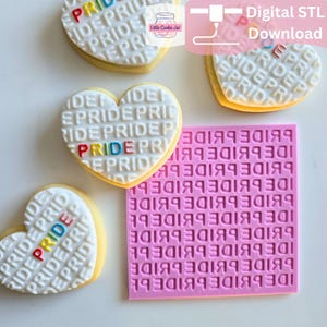 May include: A square pink silicone cookie embosser featuring a repeating grid of the word PRIDE and three heart-shaped cookies with the same embossed pattern. One cookie features the word PRIDE in multi-colored letters, while others are white.