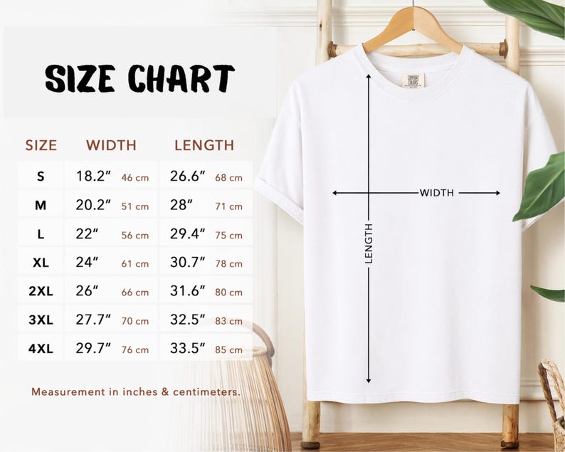 Size Chart. White t-shirt on a wooden hanger with a size chart. The chart displays measurements in inches and centimeters for sizes S to 4XL. The width measurements range from 18.2" (46 cm) to 29.7" (76 cm), and the length measurements range from 26.6" (68 cm) to 33.5" (85 cm).