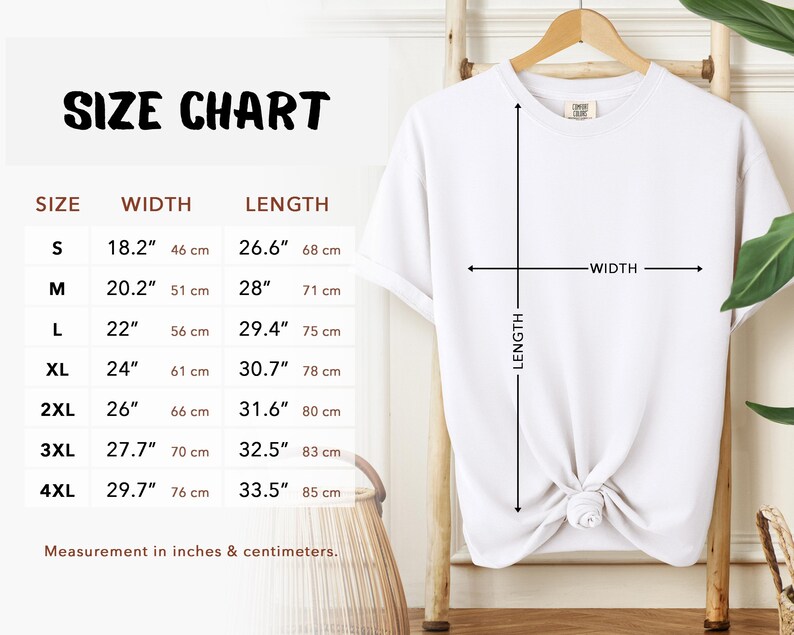 Size Chart. White t-shirt on a wooden hanger with a size chart. The chart displays measurements in inches and centimeters for sizes S to 4XL. The width measurements range from 18.2" (46 cm) to 29.7" (76 cm), and the length measurements range from 26.6" (68 cm) to 33.5" (85 cm).