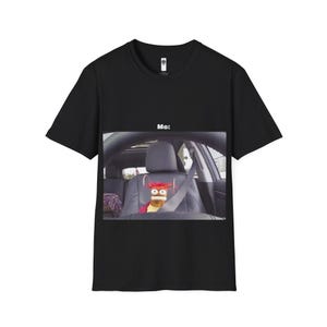 May include: Black t-shirt with a white text overlay that says "Me:" and a photo of a stuffed animal in a car seat.