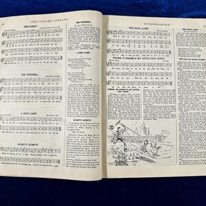 May include: A vintage book with a black and white illustration of a snail on the cover. The book is open to a page with sheet music for children's songs. The songs include "The Family", "The Windmill", "A Bird Game", "Humpty Dumpty", "The Snail Game", "Where, O Where Is My Little Dog Gone?", "Where, Oh Where Is My Little Dog Gone?", "The Tale of Peter Rabbit", and "The Wild Game".