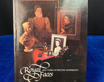 May include: A vintage hardcover book titled "Royal Faces: 900 Years of British Monarchy". The cover features a collage of portraits of British monarchs, including Queen Elizabeth I, King Henry VIII, and Queen Elizabeth II.