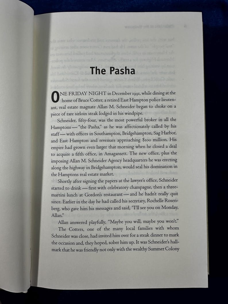 May include: A page from a book titled "The Pasha" with a black and white image of a man in a suit. The text describes a real estate broker in the Hamptons who is known as "The Pasha".