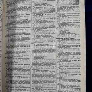 May include: A page from a vintage textbook on language and grammar. The page is printed in black and white and features a detailed explanation of the use of infinitives in English grammar. The text includes examples and explanations of different types of infinitives, such as infinitive adverbs, objective complements, and appositives.