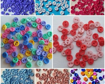 May include: Assortment of colorful two-hole buttons in various shades of blue, pink, red, yellow, and green. The buttons are small and round, perfect for sewing projects.