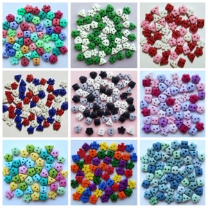 May include: A selection of colourful buttons in diverse shapes, such as squares, triangles, hearts, and flowers. The buttons are in shades of green, red, blue, purple, and yellow. These decorative buttons are suitable for sewing, crafting, and adding embellishments to clothing and accessories.
