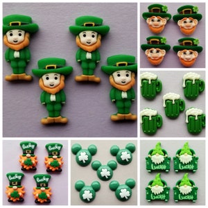 May include: Assortment of green and orange plastic buttons featuring leprechauns, shamrocks, beer mugs, and Mickey Mouse ears. The buttons are decorated with the word "lucky".