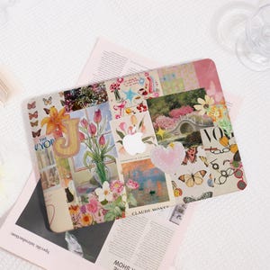 May include: A decorative laptop case featuring a collage of floral and butterfly imagery. The design includes a large letter "J", a vase of tulips, and a painting by Claude Monet. The case has a pink heart and the Apple logo.