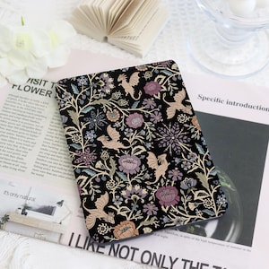 May include: Black notebook cover with a floral and dragon design. The cover features a repeating pattern of dragons, flowers, and vines in shades of beige, purple, and blue on a black background. The text "I LIKE NOT ONLY THE" is visible.