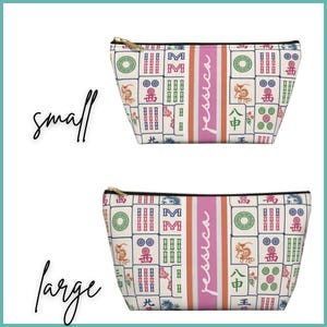 May include: Two zippered cosmetic bags with a Mahjong tile pattern in cream, red, green, and blue. The bags have a pink stripe with the name "Jessica" printed vertically. One bag is labeled "small" and the other "large".