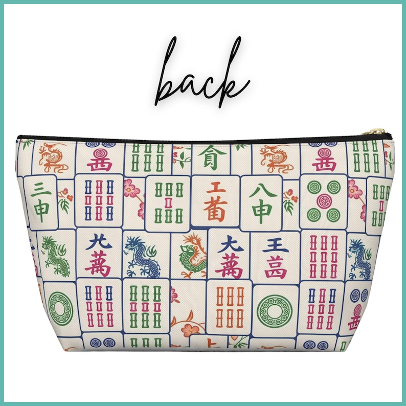 May include: A cream-coloured zippered pouch with a pattern of colourful Mahjong tiles. The tiles display various symbols, dragons, and Chinese characters. The word "back" is written in black script above the pouch.