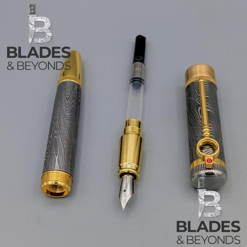 May include: A disassembled fountain pen with a gold-colored nib and accents. The pen's barrel and cap feature a patterned design. The image includes the text "BLADES & BEYONDS".