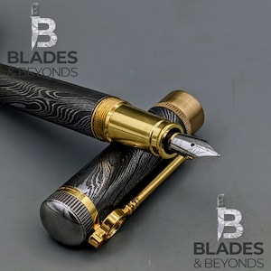 May include: A luxury fountain pen with a patterned black and silver barrel, gold accents, and a silver nib. The pen is partially disassembled, with the cap and body separated. The logo "Blades & Beyonds" is visible.