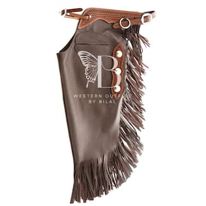 May include: Brown leather chaps with fringe and a brown leather belt with a silver buckle. The chaps have a pocket on the front and a decorative design on the back.