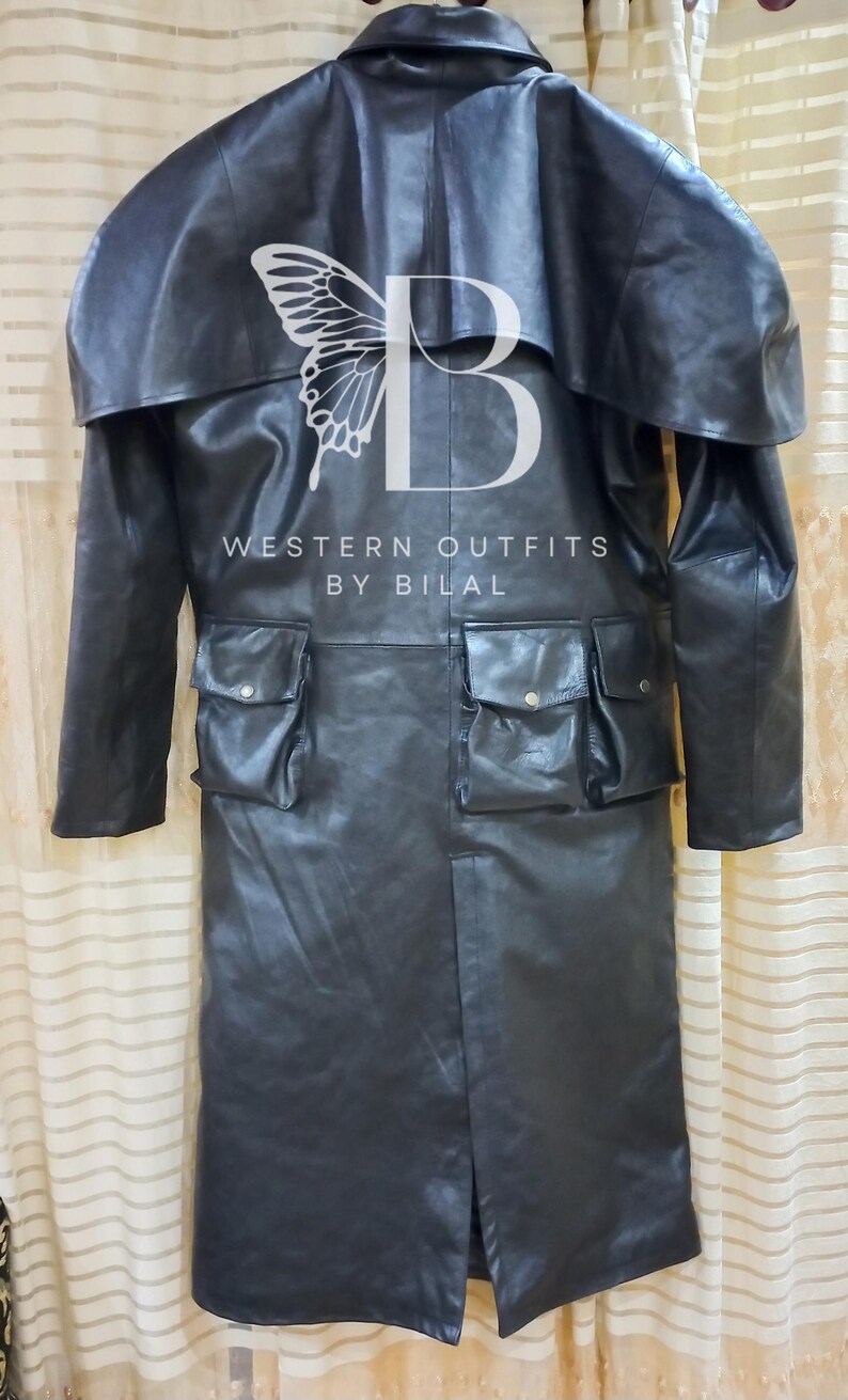 K&ouml;nnte beinhalten: Ein schwarzer Ledermantel im Western-Stil mit gro&szlig;em Kragen und zwei gro&szlig;en Taschen auf der Vorderseite. Der Mantel ist aus echtem Leder gefertigt. Der Text "WESTERN OUTFITS BY BILAL" ist auf der Vorderseite des Mantels aufgedruckt.
