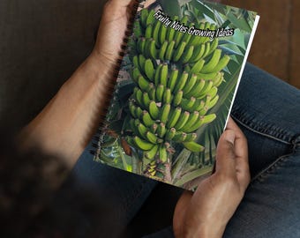 May include: A spiral bound notebook with a green banana bunch on the cover. The cover has the text "Fruity Notes Growing Ideas".