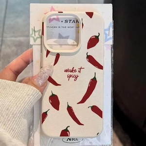 May include: A cream-coloured phone case featuring a design of red chilli peppers. The case has the phrase "make it spicy" in red script. The top of the case has the word "STAR" and the phrase "PPINESS IS THE MOST IMP". The word "NICE" is at the bottom.