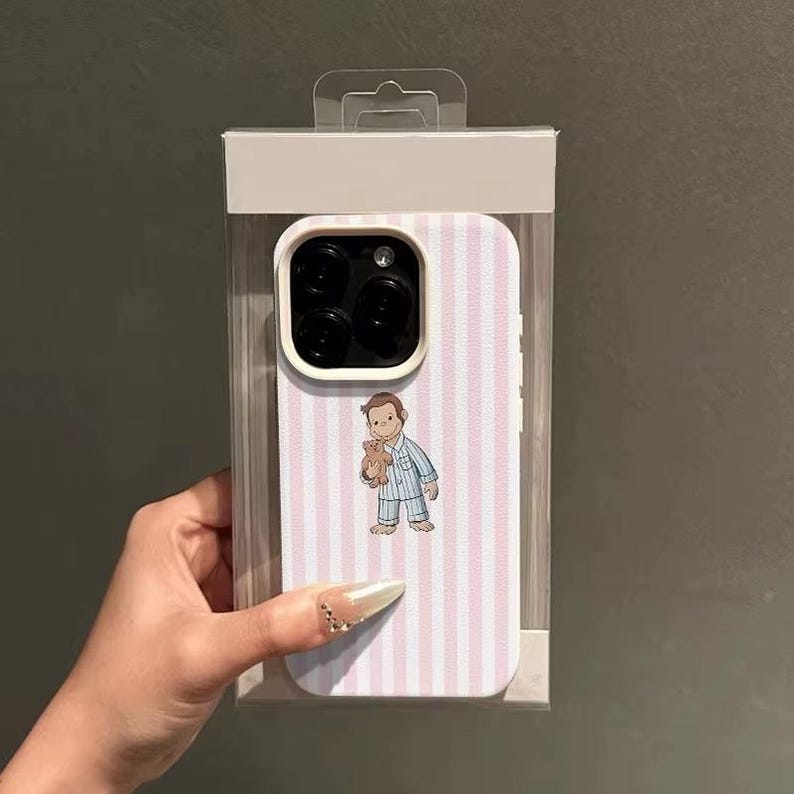 May include: A phone case with a pink and white striped pattern. The case features an illustration of a cartoon character holding a teddy bear. The case is in a clear plastic package.