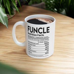 May include: A white ceramic mug featuring black text that reads FUNCLE Nutrition Facts, listing serving size as 1 Awesome Uncle and various percentages for attributes like Unconditional Love, Unrivaled Skill, Humor, Caring, Wrong Answers, and Caffeine.