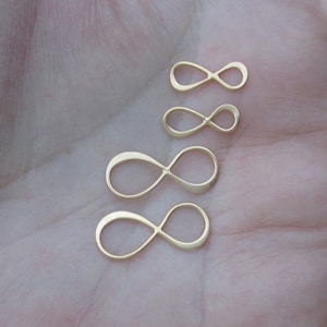 May include: Four gold infinity symbol charms of different sizes.