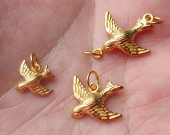 May include: Three gold-tone bird charms with a detailed design. The charms are in various sizes and are perfect for jewelry making.