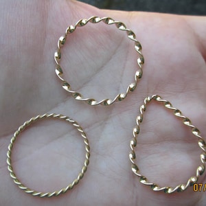 May include: Three gold-colored twisted wire rings of different sizes.