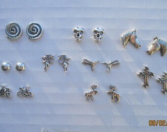 May include: A collection of 14 pairs of silver earrings featuring various designs, including swirls, skulls, horses, basketballs, birds, cross, moose, and bicycles.