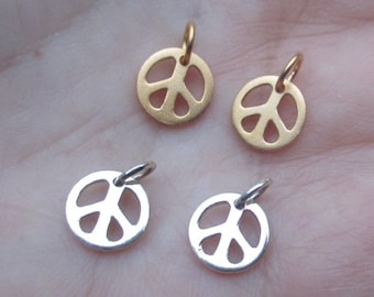 May include: Four peace sign charms, two gold and two silver. The charms are small and delicate, perfect for adding a touch of peace and love to jewelry.