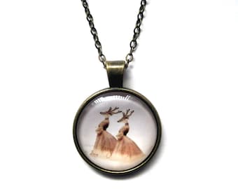 A touch of humor- Elk Ladies Glass Pendant Necklace. Brass base with 18 inch brass chain.