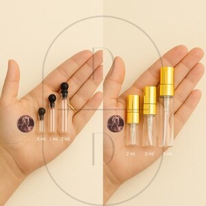 May include: Clear glass perfume bottles with black and gold caps, and gold spray tops. The bottles are labeled with their sizes: 5 ml, 1 ml, 2 ml, 2 ml, 3 ml, and 5 ml. A penny is included for size comparison.
