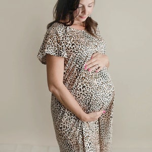 Plus Size pregnant mom wearing leopard hospital delivery gown to deliver baby. Fabric is soft and stretch with snaps at shoulder for breastfeeding and down back for epidural. Long enough to cover knees. Favorite baby shower gift from mother in law.