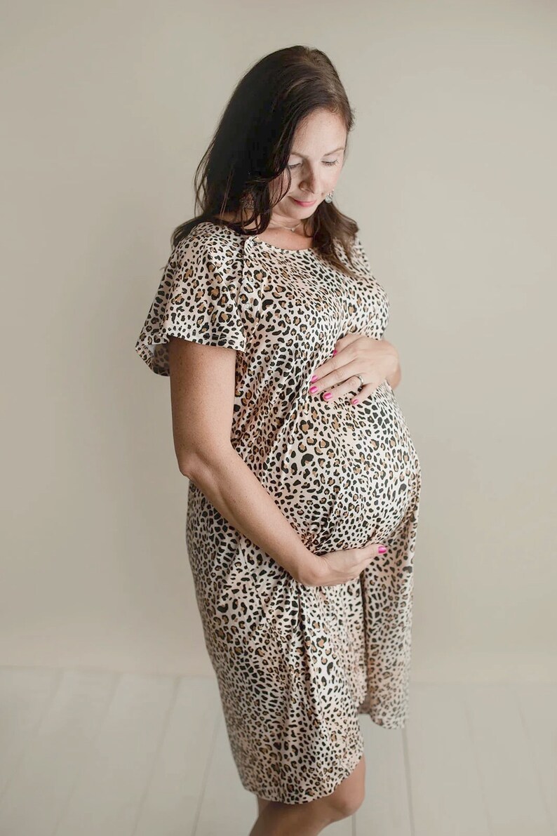 Plus Size pregnant mom wearing leopard hospital delivery gown to deliver baby. Fabric is soft and stretch with snaps at shoulder for breastfeeding and down back for epidural. Long enough to cover knees. Favorite baby shower gift from mother in law.