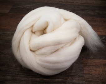 May include: A large clump of white wool fiber, perfect for felting or spinning.