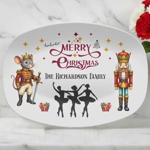 May include: An oval white serving platter featuring a colorful illustration of a mouse in a red soldier uniform with a sword, a nutcracker, and three black silhouettes of ballerinas. The text reads Merry Christmas and The Richardson Family.