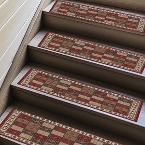 May include: Stair treads with a geometric pattern in shades of red, brown, and beige. The rectangular treads have a border design and are placed on wooden stairs, offering a decorative and functional element for home decor.