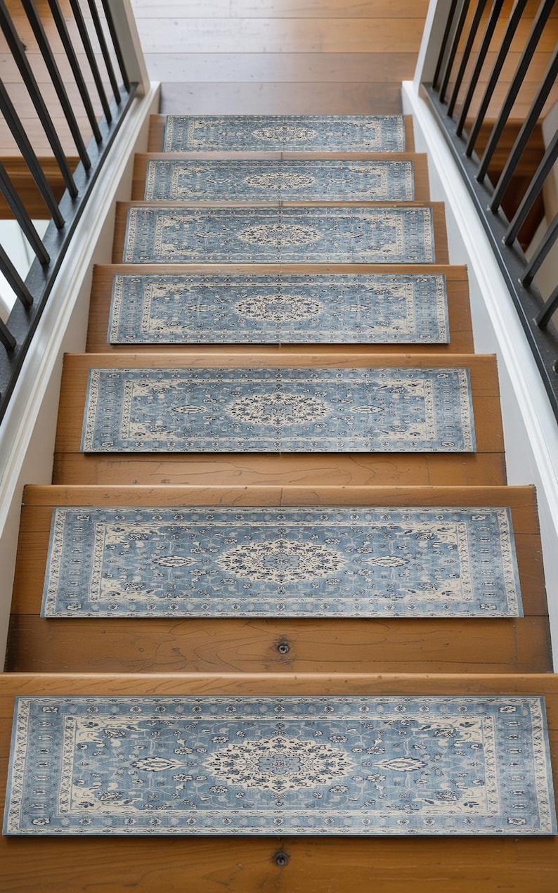 A set of wooden stairs with blue and white patterned rugs placed on the steps, leading up to a higher level.