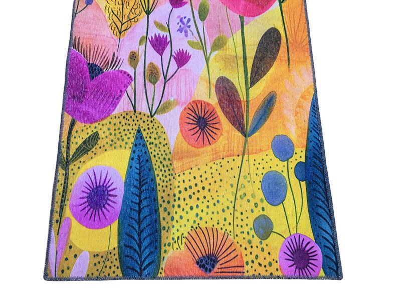 The image is a vibrant and colorful abstract pattern featuring various flowers, leaves, and other natural elements in a variety of bright colors, including shades of pink, orange, yellow, and blue.