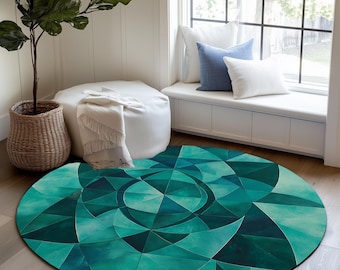 May include: A round, teal and green area rug with a geometric pattern of triangles and circles. The rug is on a light wood floor in a room with a white window seat and a potted plant.