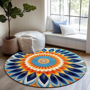 May include: A circular area rug featuring a vibrant, symmetrical mandala pattern with concentric layers of deep blue, bright orange, and soft cream petals radiating from a central point, creating a bold, colorful floral-inspired design.