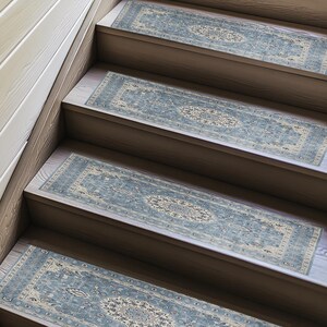 a set of wooden stairs with blue and white patterned rugs placed on the steps.