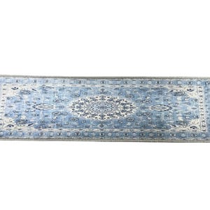 a large, blue and white rug with a floral pattern.